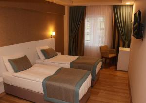 Postel nebo postele na pokoji v ubytování ParionHouse Hotel