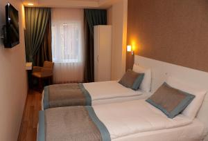 Postel nebo postele na pokoji v ubytování ParionHouse Hotel