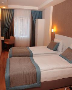 Postel nebo postele na pokoji v ubytování ParionHouse Hotel