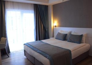 Postel nebo postele na pokoji v ubytování ParionHouse Hotel