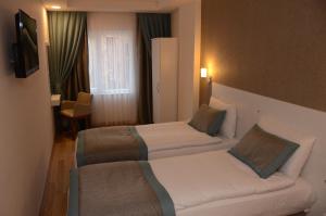 Postel nebo postele na pokoji v ubytování ParionHouse Hotel