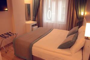 Postel nebo postele na pokoji v ubytování ParionHouse Hotel