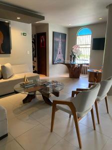 a living room with a couch and a table at Hotel Encontro do Sol in Fortaleza