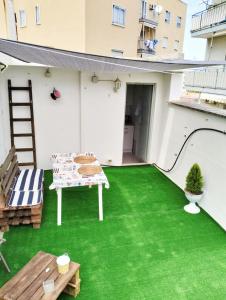 a patio with green grass on a building at Petracca Guest House in Monopoli