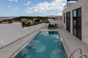 a swimming pool on the balcony of a house at Perla Dream Luxury Villa in Chania Town