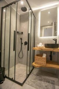 a shower with a glass door in a bathroom at Μοντέρνο διαμέρισμα ALMYRA in Agios Nikolaos