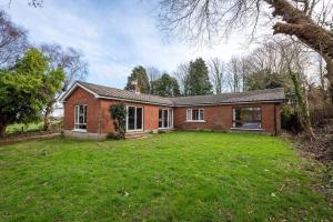 a brick house with a large yard in front of it at Tai Chi House, T Dempsey's house in Waterford