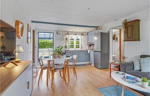 a kitchen and living room with a table and chairs at 3 Bedroom Cozy Home In Nykøbing Sj in Lumsås