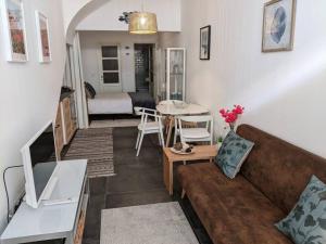 a living room with a couch and a table at the light house in Vila Real de Santo António