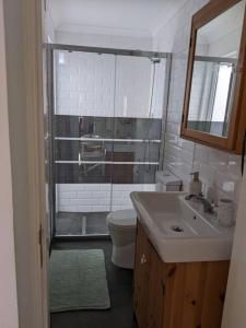 a bathroom with a toilet and a sink and a mirror at the light house in Vila Real de Santo António