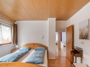 a bedroom with two beds and a wooden ceiling at Modern Holiday Home in Nordenau with Private Terrace in Schmallenberg