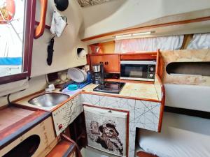 eine kleine Küche mit einer Spüle und einer Mikrowelle in der Unterkunft Lanzarote Pirat in Arrecife