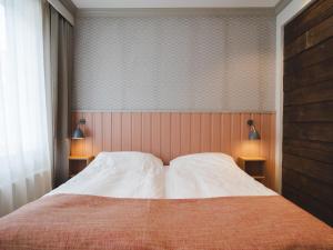 Postel nebo postele na pokoji v ubytování Grand Hotel Egersund