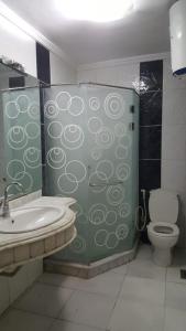 a bathroom with a shower with a toilet and a sink at ستانلي اسكندريه in Alexandria