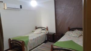 a small room with two beds in it at ستانلي اسكندريه in Alexandria