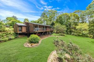 a home with a large yard with a house at Hinterland family getaway in Maleny