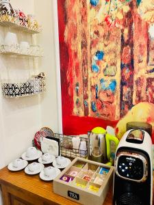 a kitchen counter with a coffee maker and a tea kettle at ConteMax ArtHouse in Salerno