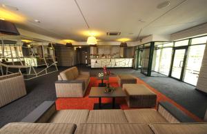 a lobby with couches and tables in a building at Villa Four Rooms in Kharkiv