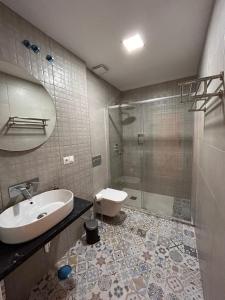 a bathroom with a toilet and a sink and a shower at Apartamentos Esencia in Ronda +36 photos