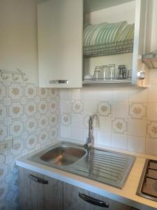 a kitchen with a sink and a counter at Casa tra i Trulli in Martina Franca