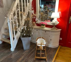 a room with a staircase and a chair and a mirror at Chez Patou in Laval