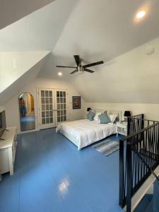 een slaapkamer met een bed en een plafondventilator bij The Paddock House at Blanco Texas in Blanco