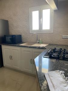 a kitchen with a sink and a counter top at Villa Luna Domaine Béluga Bounouma kerkennah in Sfax