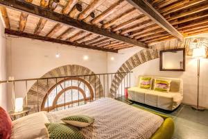 a bedroom with a bed and a couch in a room at The Loft in Rome