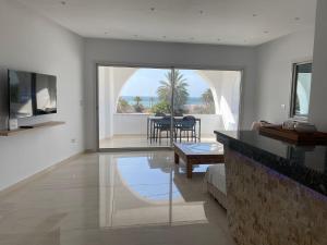 a living room with a couch and a table at Villa Luna Domaine Béluga Bounouma kerkennah in Sfax