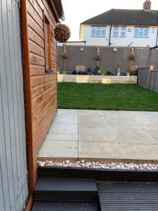 a door to a house with a garden and a yard at Art Deco Property in Bromley in London