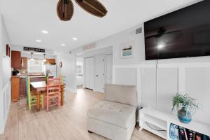 a living room with a chair and a dining room at Villas on the Gulf unit C5 in Pensacola Beach