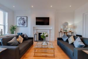 a living room with two couches and a fireplace at 80 by Elite in Liverpool