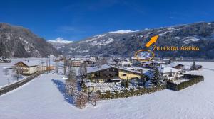 an aerial view of a resort in the snow at Boutiquehotel Säumler in Zell am Ziller