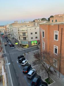 a city street with cars parked in a parking lot at Labanca’s Home in Matera