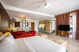 a bedroom with a bed and a living room at The Pink Palm Hotel - Adults Only in Charlotte Amalie