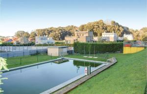a large pool of water in a park with houses at Apartamento Aldeana in Llanes