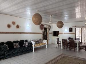 a living room with a couch and a table at Fred Hunter Villa in Tiwi