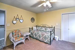 a bedroom with a bed and a chair and a ceiling fan at Relaxing Helotes Pad 7 Mi to UT at San Antonio! in San Antonio