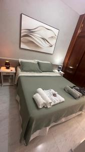 a bedroom with a bed with towels on it at Ipanema Tiffany´s 2 suites. Novo in Rio de Janeiro