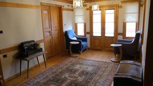 a living room with two chairs and a rug at Utku Konağı in Bartın