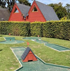 a house with a play set in the yard at Chalet 95, Kingsdown Park in Deal