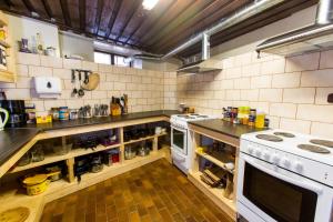 a kitchen with a stove and a counter top at Old Town Hostel Alur in Tallinn