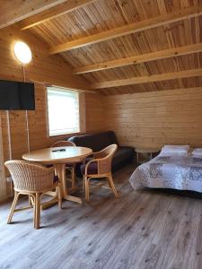 a room with a bed and a table and chairs at Siodemkacamp Karwia in Karwia