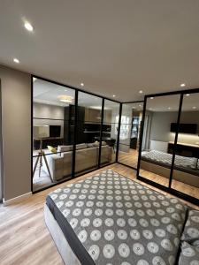 a bedroom with a large bed and a living room at Osiedle Legionów Apartament in Kielce +2 photos