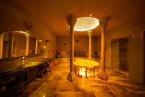 a large bathroom with a tub and a large mirror at Shoestring Cave House in Goreme