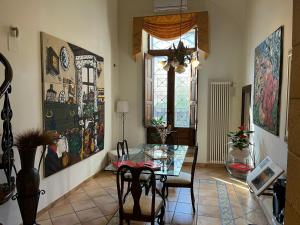 a dining room with a glass table and a window at Loft tanzi in Bari +25 photos