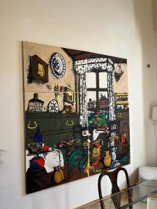 a painting hanging on a wall in a living room at Loft tanzi in Bari
