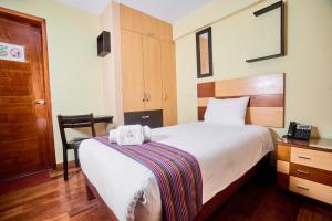 Postel nebo postele na pokoji v ubytování Samkauta Hotel & Suite + 18 fotografií