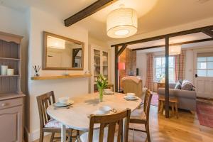 a dining room and living room with a table and chairs at Bunny Cottage by Bloom Stays in Hythe