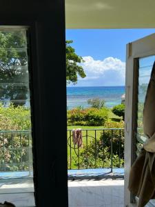 a room with a view of the ocean from a balcony at Carib condo in Ocho Rios